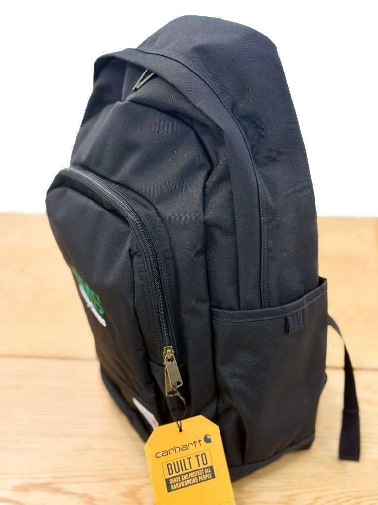 Side angle of BMS Black Carhartt 25L Backpack highlighting water-repellent fabric, side pocket, and Carhartt tag for industrial use.