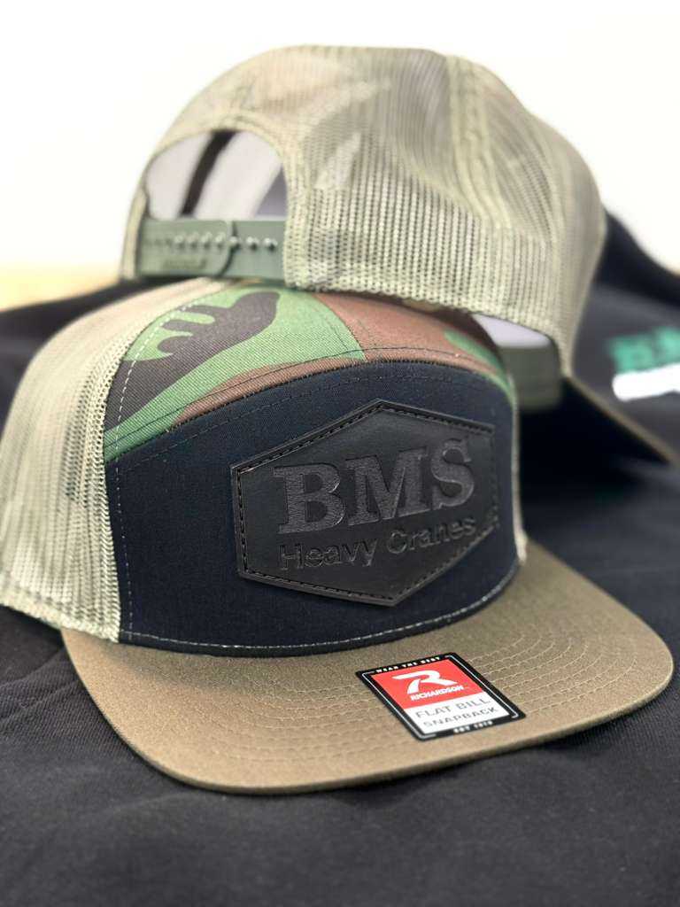 Adjustable snapback BMS camo truck hat with breathable mesh back and bold BMS Heavy Cranes logo, perfect for industrial streetwear style.