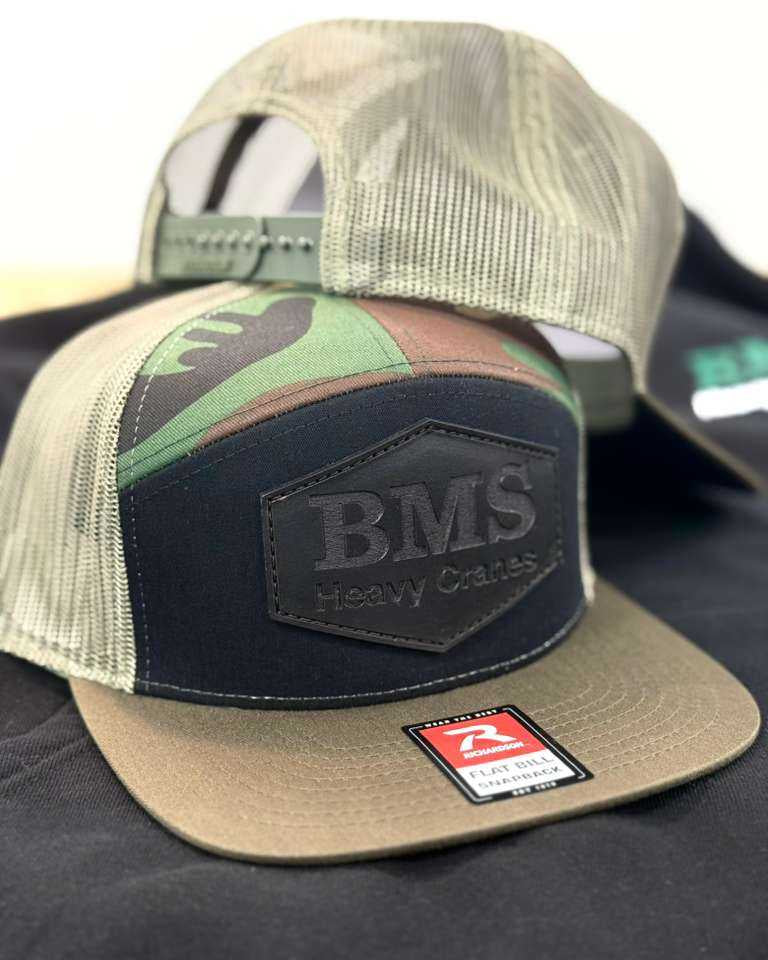 Adjustable snapback BMS camo truck hat with breathable mesh back and bold BMS Heavy Cranes logo, perfect for industrial streetwear style.