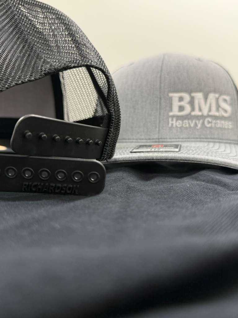 Close-up of BMS Trucker Hat's snapback closure and mesh back, highlighting adjustable fit and durable construction.